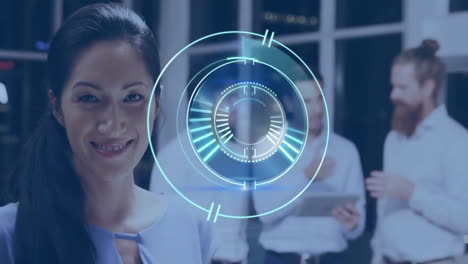 smiling woman with digital interface, colleagues discussing in background at office