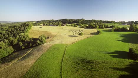 aerial view of tractor harvesting straw bales.