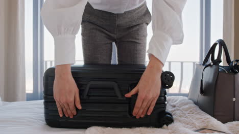 beautiful business woman packing suitcase in hotel room getting ready for road trip preparing luggage making travel plans