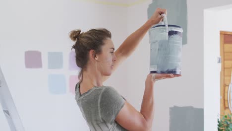 portrait of a caucasian woman in quarantine during coronavirus pandemic, doing interior work