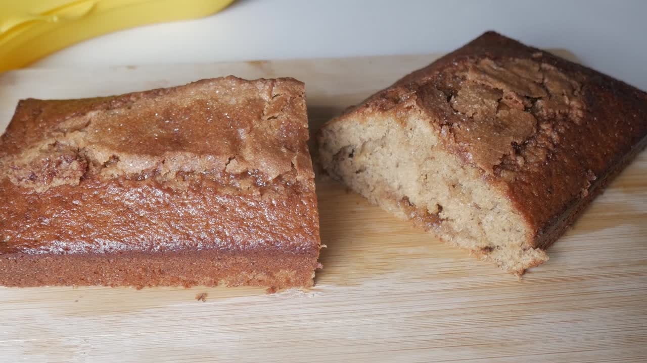 Fresh baked banana bread sliced on wooden board, simple and rustic