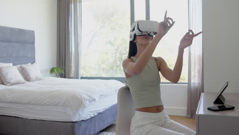 caucasian young woman wearing virtual reality headset, making hand gestures, copy space