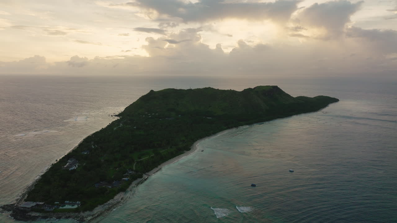 Overhead of long island coastline with reef and dramatic overcast sky