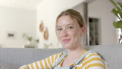 Portrait-of-happy-caucasian-teenage-girl-with-blond-hair-at-home,-slow-motion