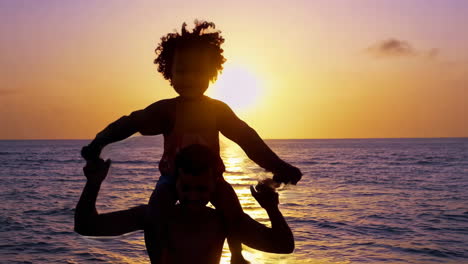 father and daughter enjoying a sunset at the beach