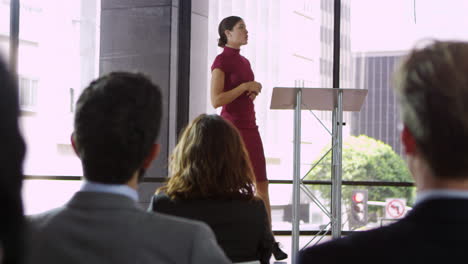 Young-woman-on-stage-presenting-a-business-seminar,-shot-on-R3D