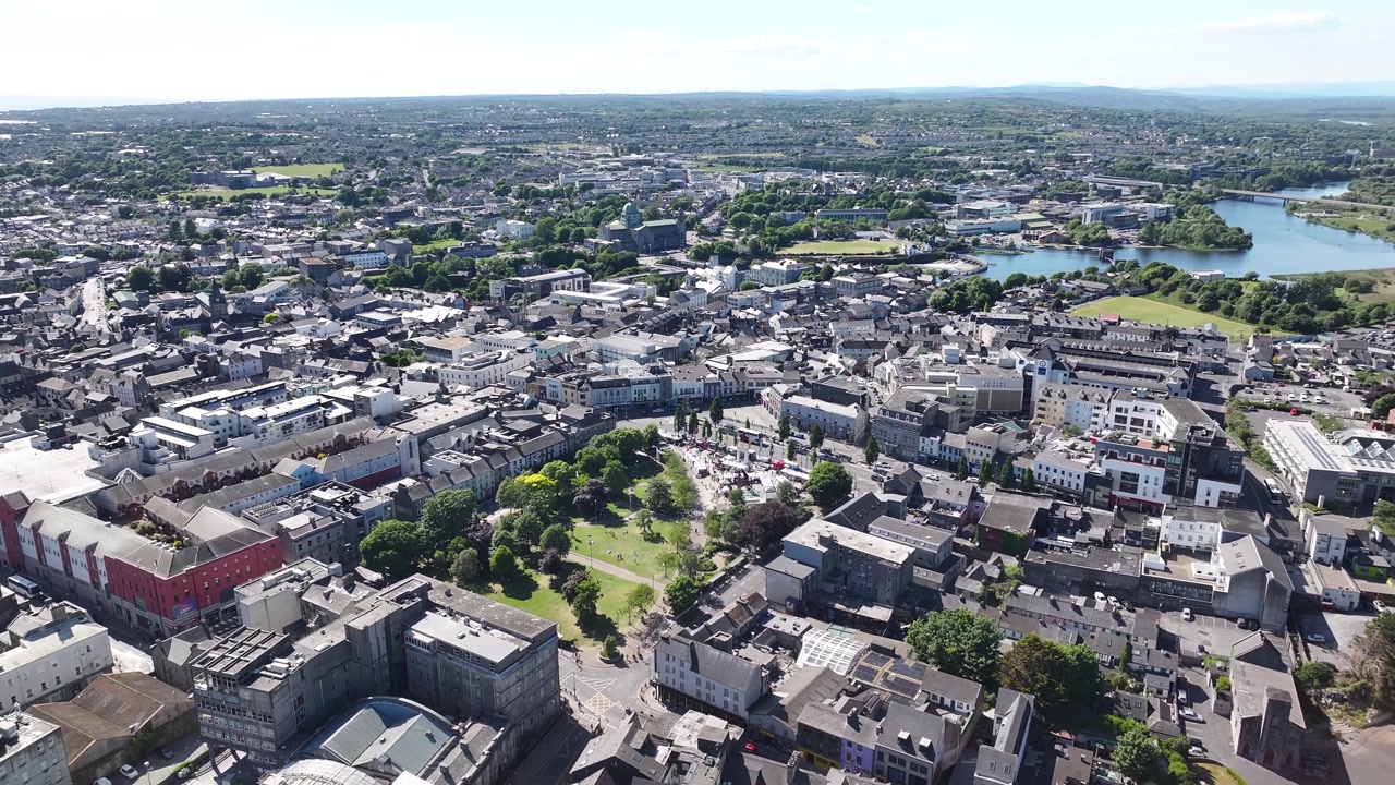 Eyre Square city park in heart of Galway, Ireland. Sunny beautiful day, aerial cityscape
