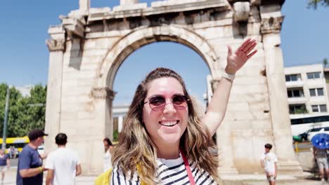joyful woman waving for a selfie at a greek landmark, athens, greece