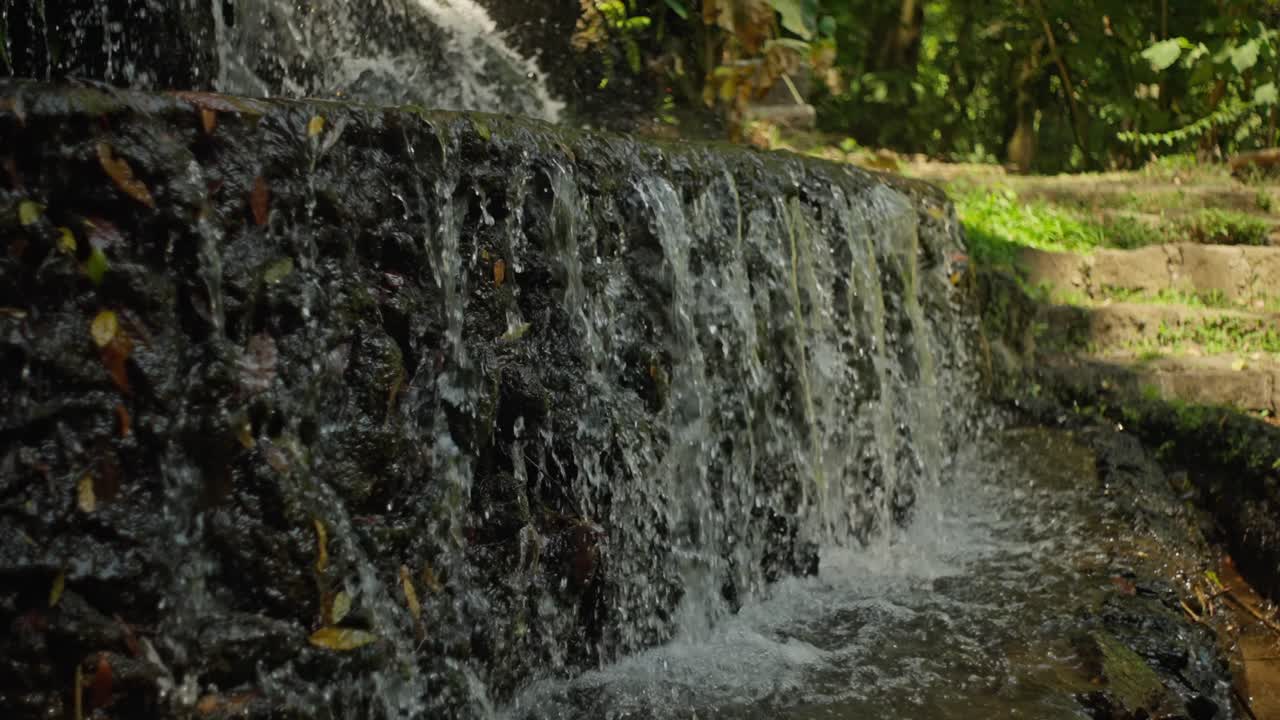 SLOW MOTION STATIC SHOT OF A SMALL WATERFALL AT URUAPAN'S NATIONAL PARK