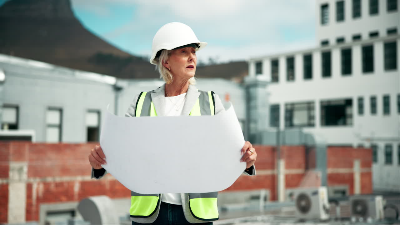 Woman in Construction Holding Blueprints