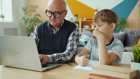 grandfather and grandson studying together