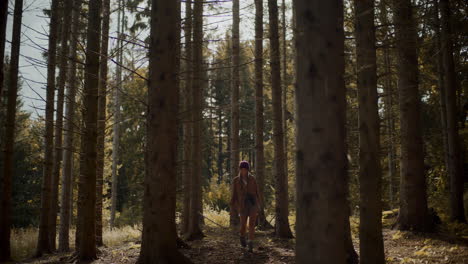 Young-female-tourist-enjoying-while-walking-in-forest