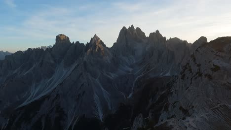 Pan-across-sharp-rugged-cliff-and-valley-grooves-of-the-Dolomite-mountain-range