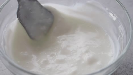 mixing yogurt in a bowl