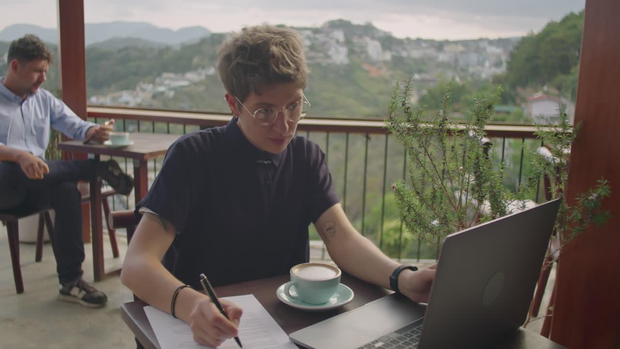 Businesswoman Working on Laptop in Cafe on Mountain Top