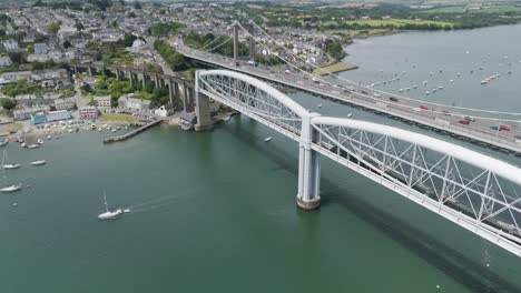 aerial view of bridges, town, and boats on a river estuary