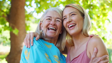 multi-generation family with senior mother and adult daughter laughing in garden together