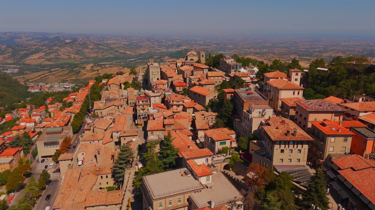 A bird’s-eye view of San Marino, showcasing its historic architecture and rolling hills in a mesmerizing drone shot.