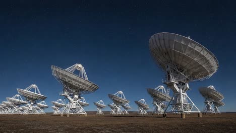 radio telescopes under a starry night sky