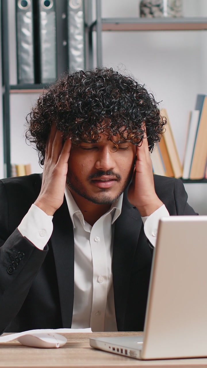 Stressed businessman work at unpaid bank debt doing paperwork planning budget throws paper bills