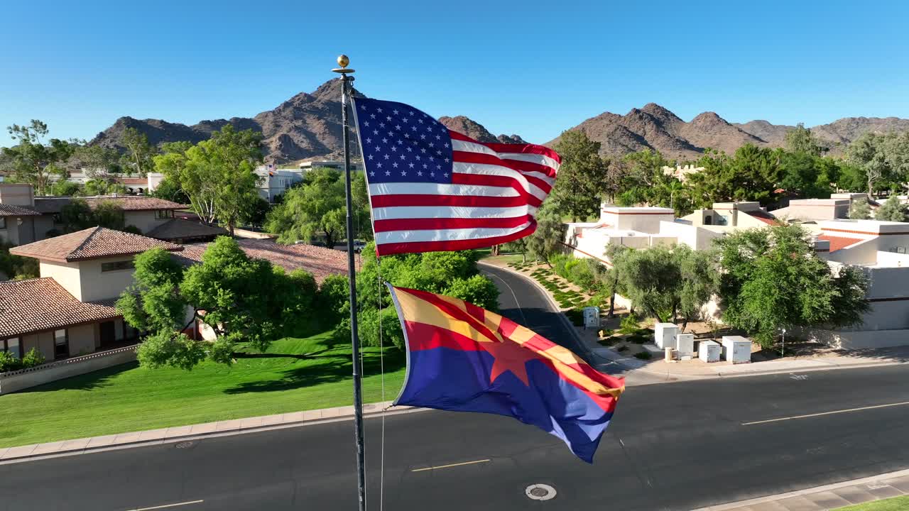American and Arizona flags waving in luxurious country club neighborhood