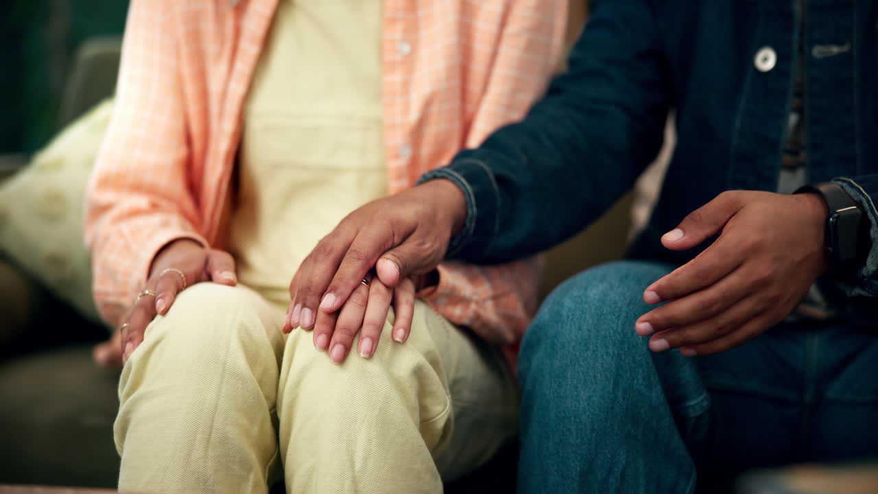 Couple holding hands in a loving and supportive moment