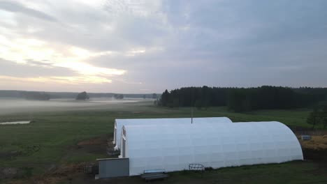 two-white-arched-hall-in-dawn-sunrise-aerial-circulating-left