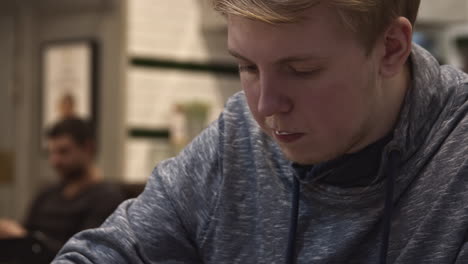 man drinking coffee in a cafe