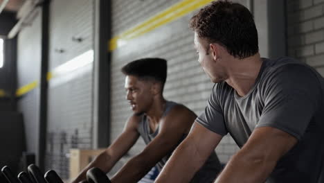 men working out on exercise bikes in gym