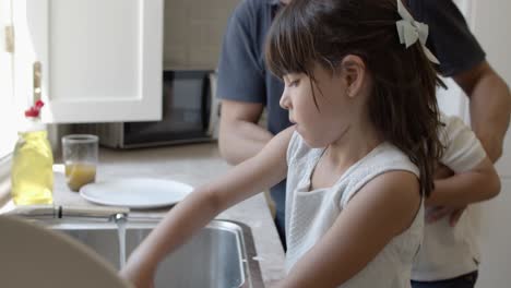 girls rubbing glass with sponge and foam