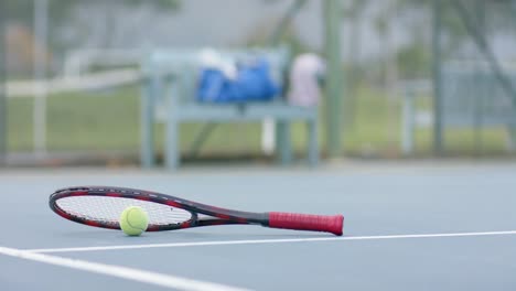 Close-up-of-tennis-racket-and-ball-on-outdoor-tennis-court,-slow-motion