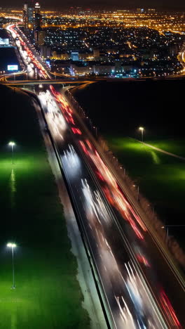 night highway with blurred car lights and city skyline