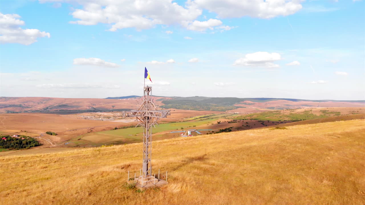 Large Cross with Romania flag on High Hill and landscape at Summer