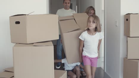 parents and two girls moving into apartment