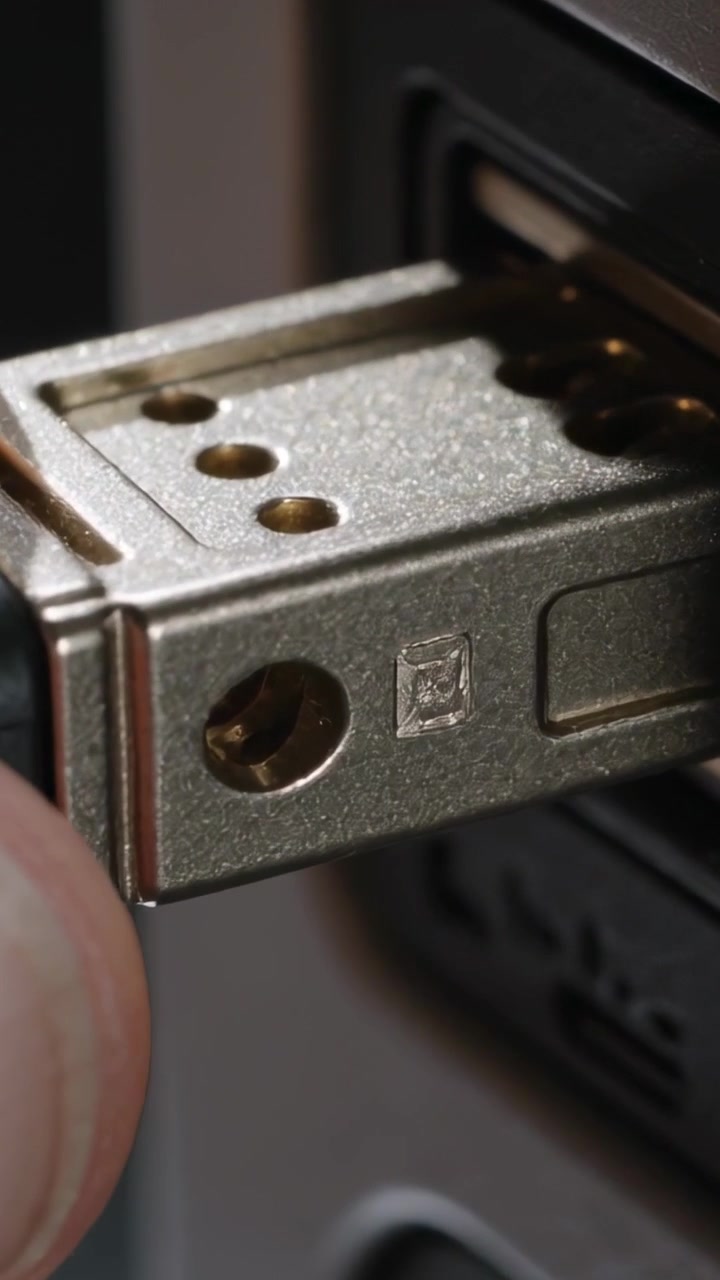 Vertical video: Holding metal connector user nudging plug into side port on desk device to connect