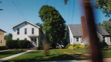 ride along typical american suburbs from the window of the car you can see wooden houses and neat la