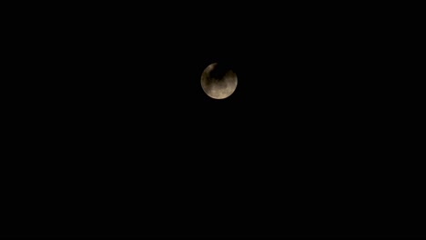 time lapes during the red moon, when it is in full form, with slightly clouds obscuring the moon