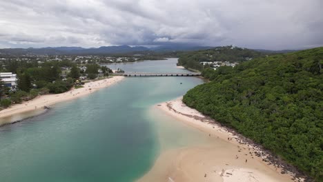 tallebudgera creek with blue water by burleigh headland - burleigh head national park in gold coast, qld, australia. - aerial shot