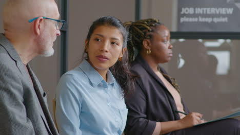 hispanic woman speaking with senior man before job interview