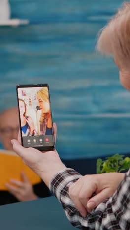 vertical video: senior woman having video call with nephew