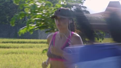 sporty woman running through rural area