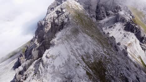 Aerial-of-steep-rocky-alpine-mountain-rang-ridge,-epic-landscape-drone-scenery-view-flying-over