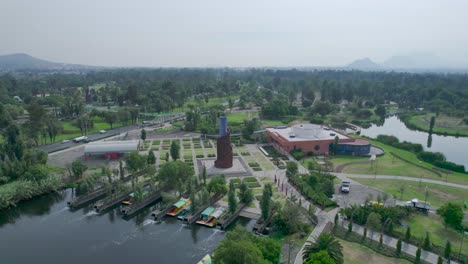 Orbital-footage-with-view-of-a-lake,-a-highway-and-a-natural-area-in-Mexico-City