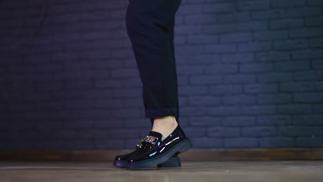 black loafers with chain detail on women's legs