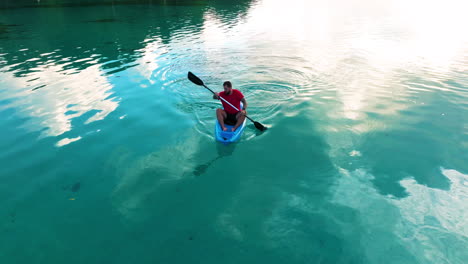 view of a man on kayak in early morning, moso island, vanuatu - drone shot