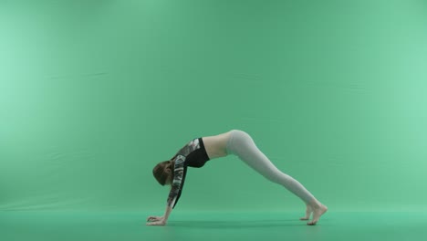 woman in yoga pose on a green screen