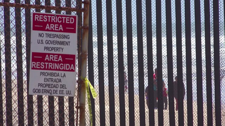 Signs warn of a restricted area at the US Mexico border fence in the Pacific Ocean between San Diego and Tijuana 1