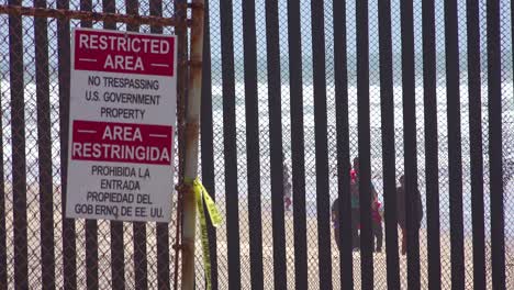 signs warn of a restricted area at the us mexico border fence in the pacific ocean between san diego and tijuana 1