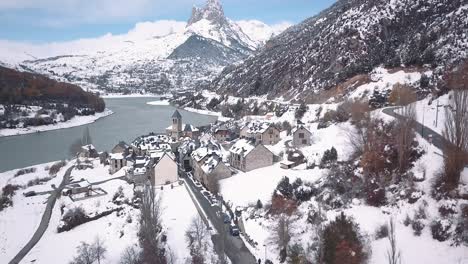 drone crane shot over the village of lanuza in the spanish pyrinees after the first snowfall of the season