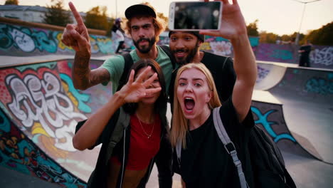 friends taking expressive selfies at a vibrant skate park during golden hour